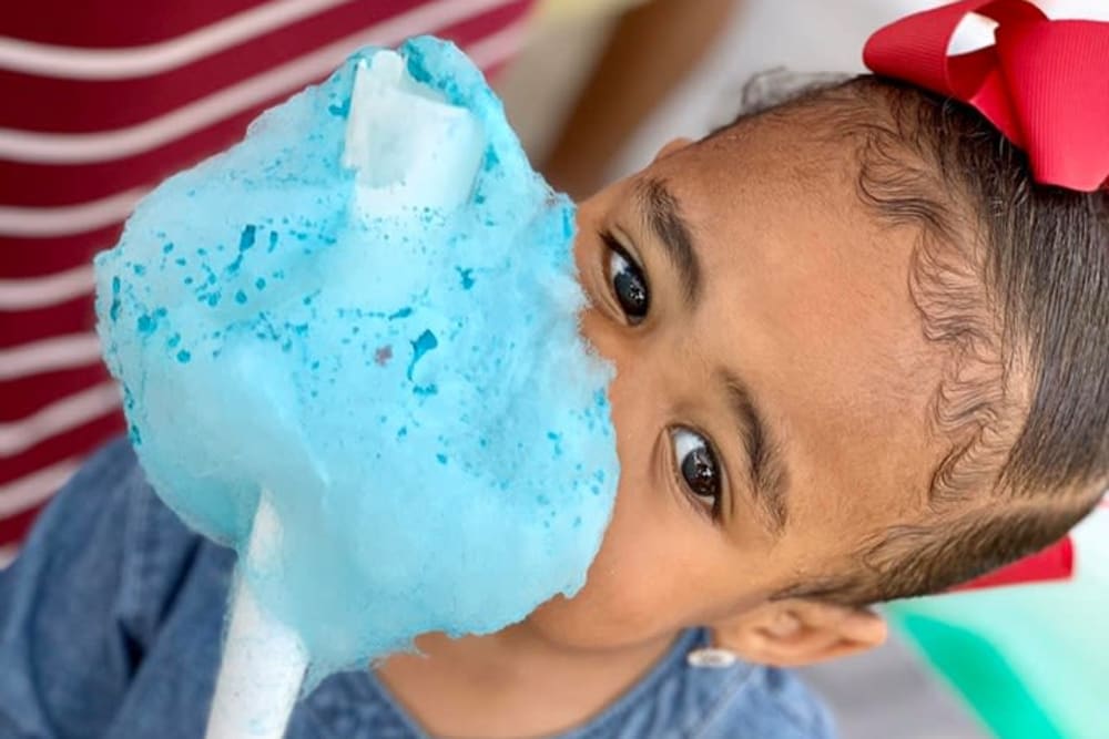 Child enjoying some tasty cotton candy at a resident event at The Mayfair Apartment Homes in New Orleans, Louisiana