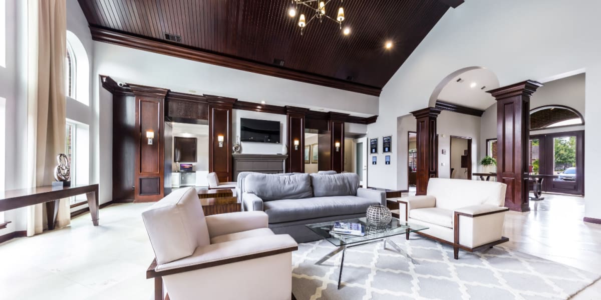Community clubhouse main sitting area with couches and vaulted ceilings at Marquis on Park Row in Houston, Texas