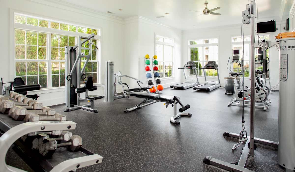Well-equipped fitness center with various exercise equipment at Madison Park in Madison, Alabama