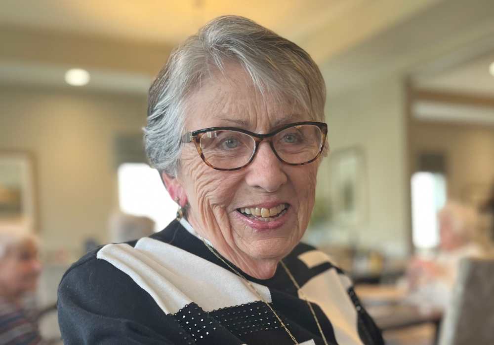 Resident posing with a glass of wine at Merrill Gardens at West Chester in West Chester, Pennsylvania