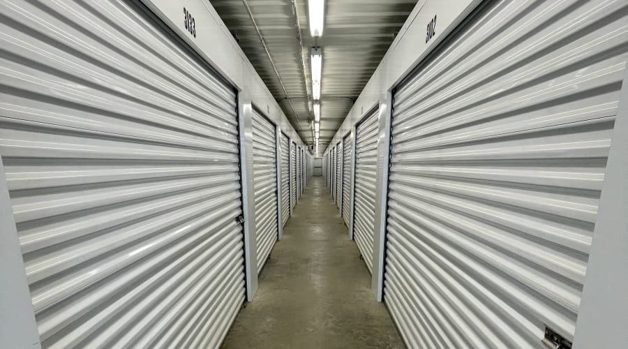 A family carrying storage boxes into their new home near KO Storage in Evans Mills, New York