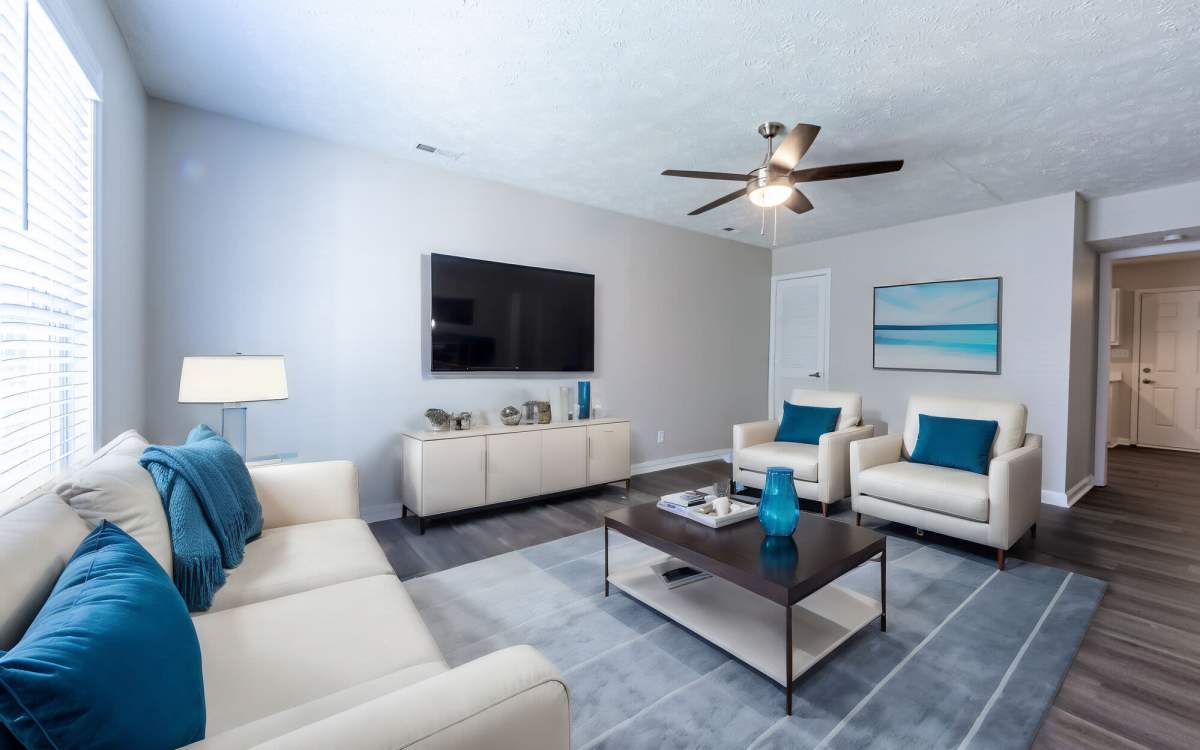 Spacious and well-furnished living area with hardwood flooring at Cape Fear Townhomes in Fayetteville, North Carolina
