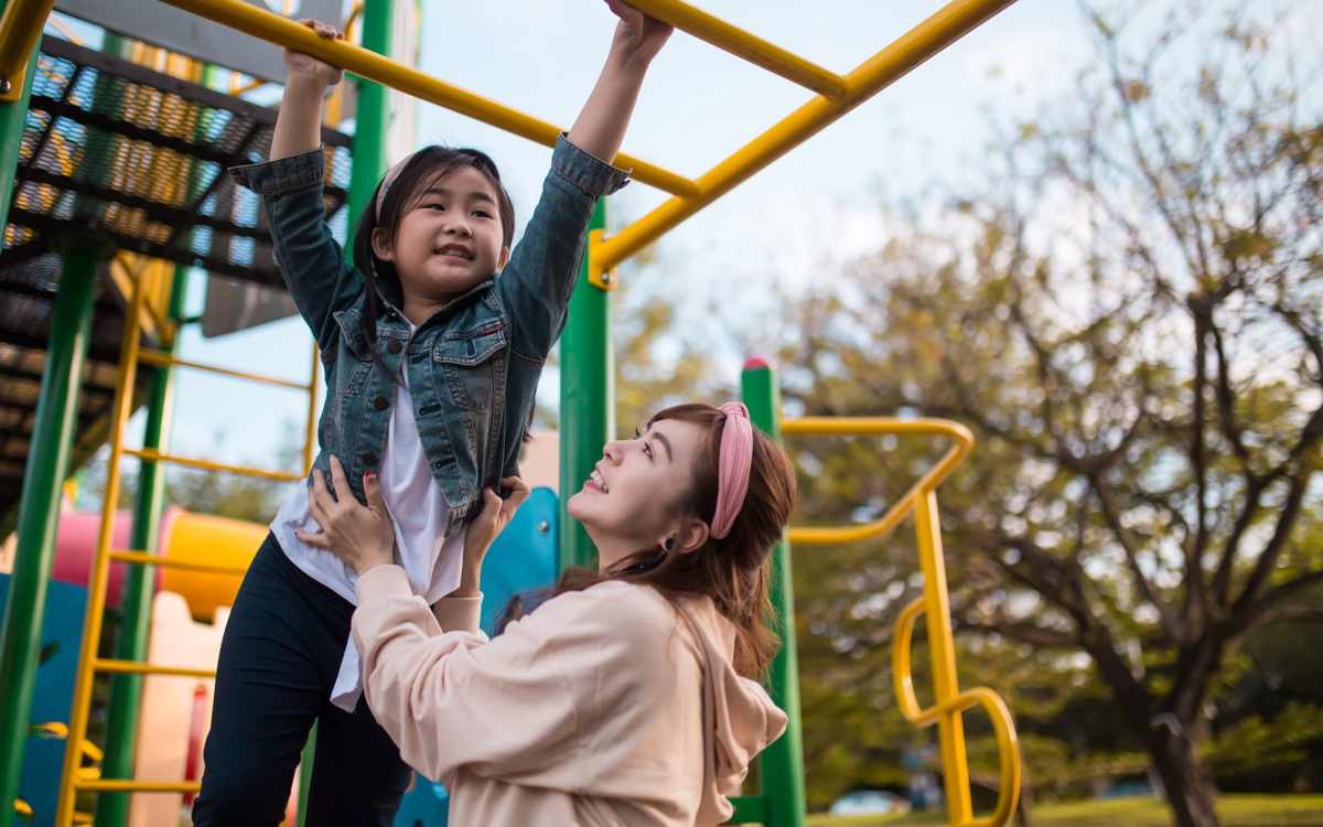 Resident with her daughter in the playground at Landmark Apartments in Chesapeake, Virginia