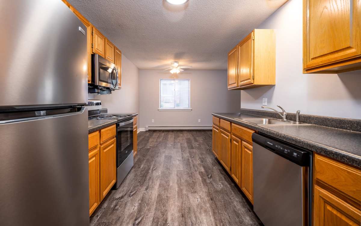 Kitchen with dishwasher at Oakwood Manor Apartments in Fairport, New York