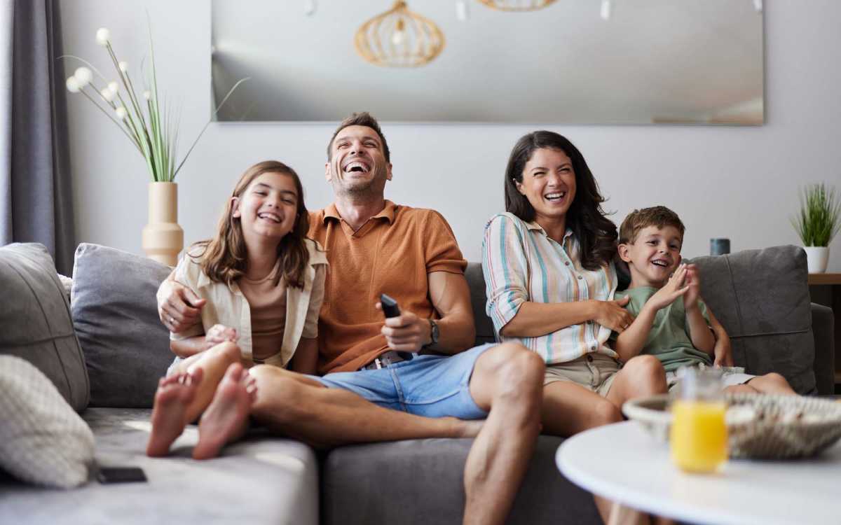 Family enjoying their time on the couch at Vista Sol El Paso in El Paso, Texas