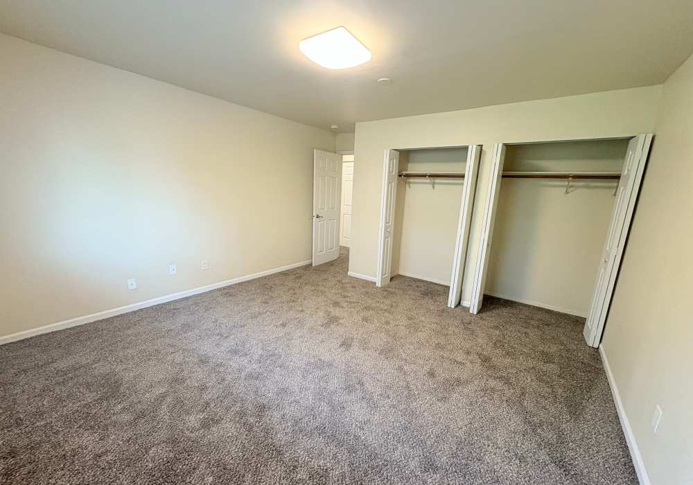 Unfurnished bedroom having a closed walk-in closet at Edgewood Group Apartments in Merrillville, Indiana