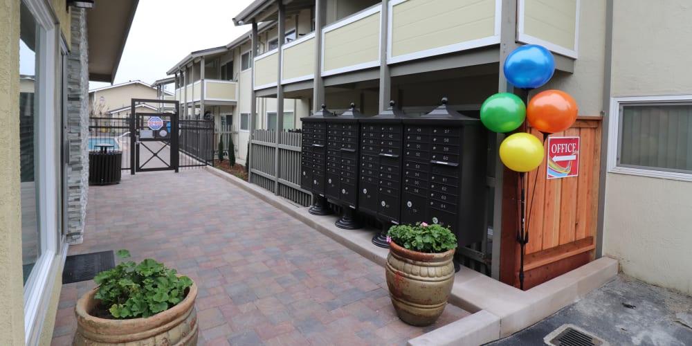 Outdoor mailboxes and pool entrance at Fremont Arms Apartments in Fremont, California