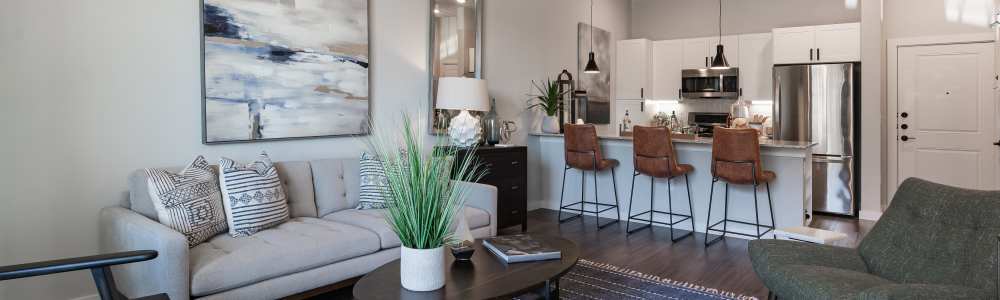 A spacious living space and kitchen in an apartment at The Trails at Summer Creek in Fort Worth, Texas