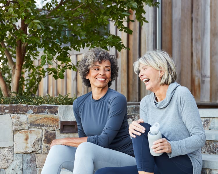 Residents chatting on the steps outside their home after a workout in the fitness center at Sofi Irvine in Irvine, California