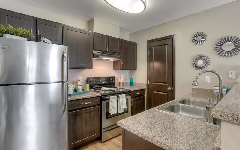 Kitchen with stainless steel appliances at Pebble Cove Apartments in Renton, Washington