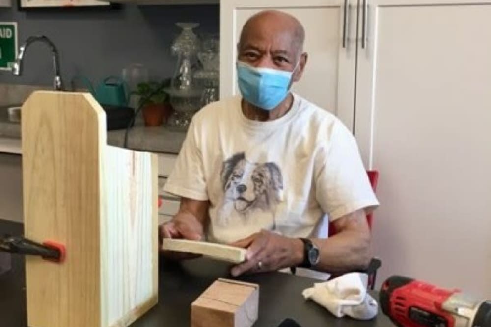 A resident building a wood birdhouse at Mercer Hill at Doylestown in Doylestown, Pennsylvania