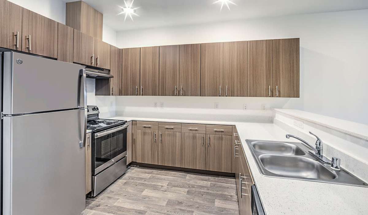 Modern kitchen with wooden flooring at Melody in Las Vegas, Nevada