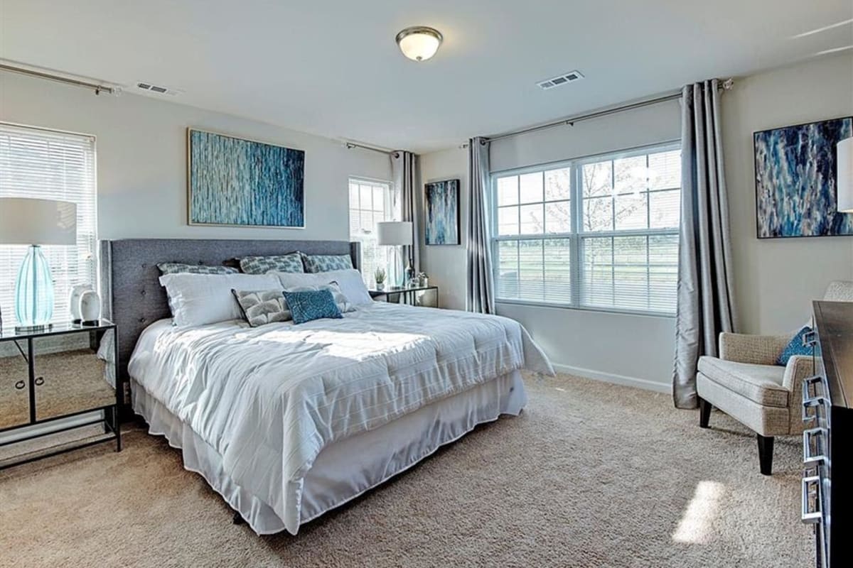 Bedroom with bright windows at Ashwood Place in Naperville, Illinois