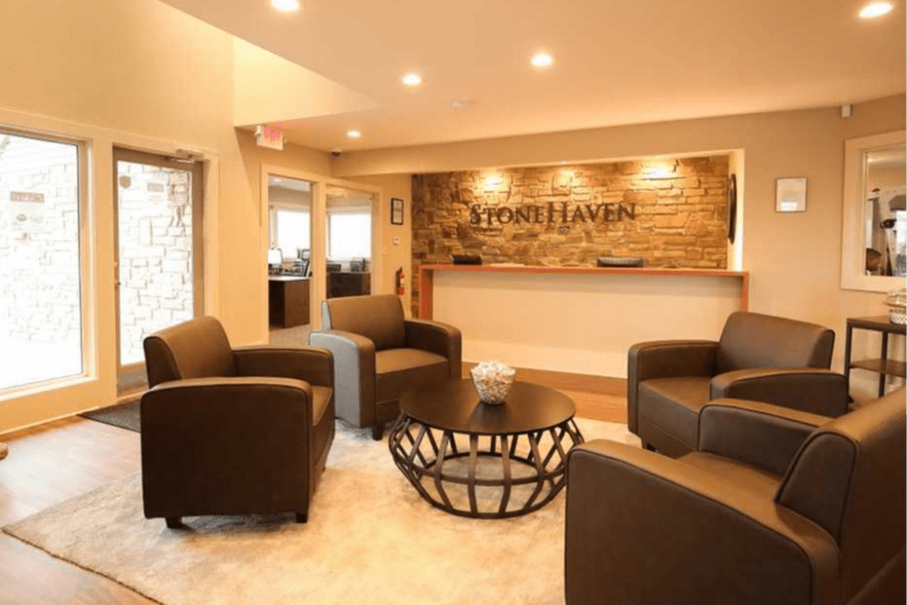 Clubhouse with seating area at Stonehaven Apartments in Hazelwood,Missouri