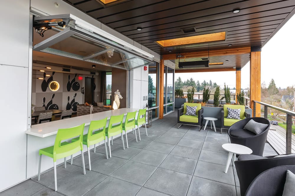 Lounge areas outside the rooftop resident lounge at ArLo Apartments in Portland, Oregon