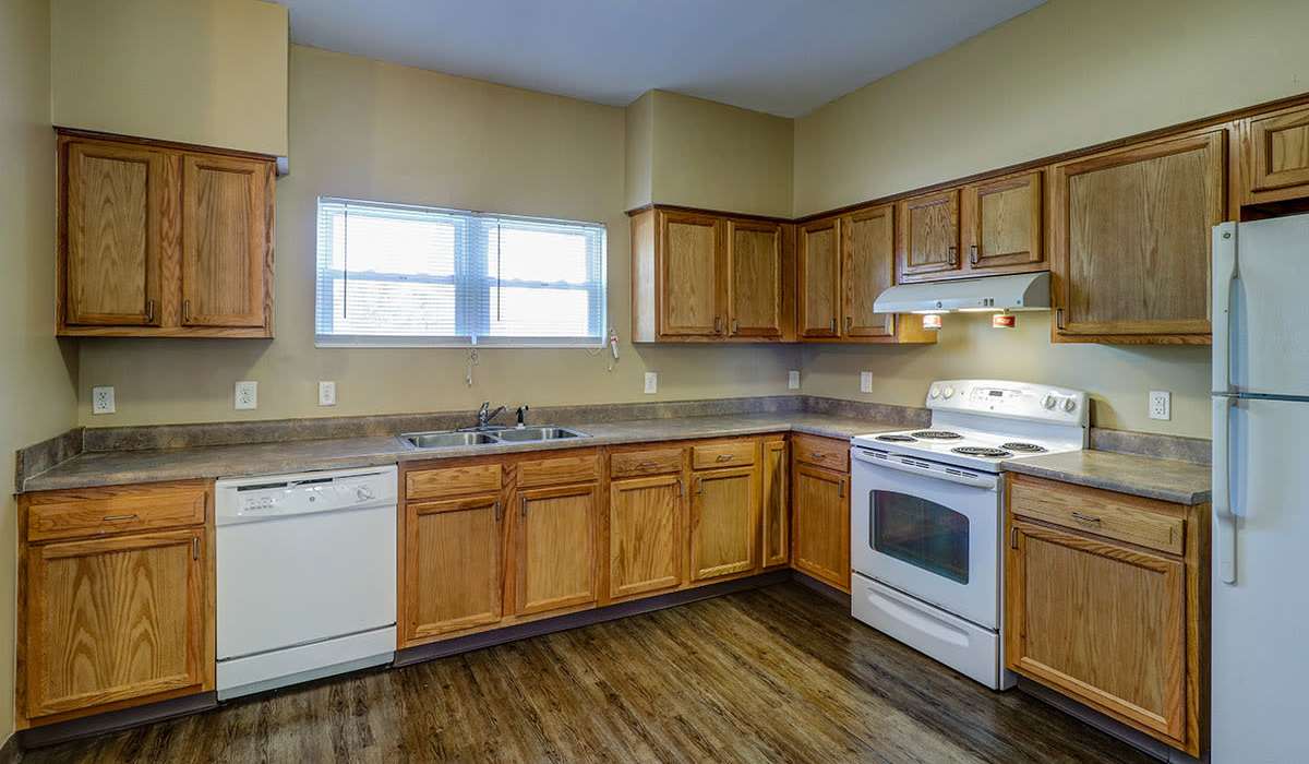 Kitchen with modern appliances in the apartment at Harmony Greene in Pooler, Georgia