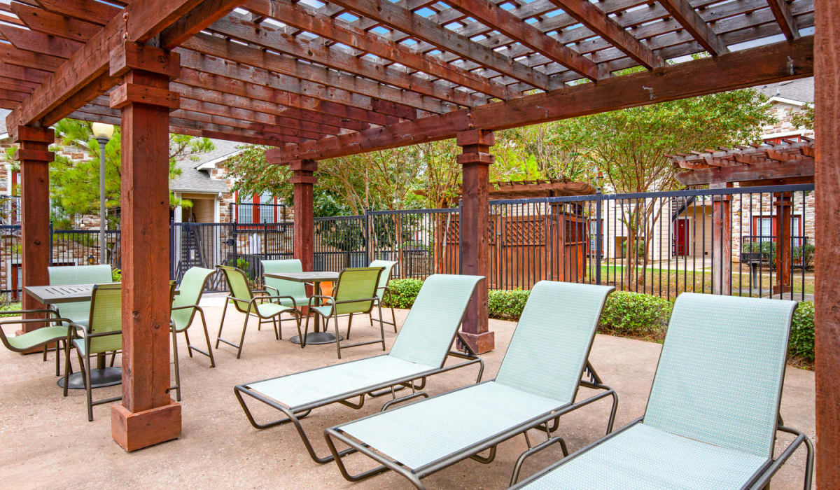 Patio with lounge chairs at Walnut Ridge Apartments, Bastrop, Texas