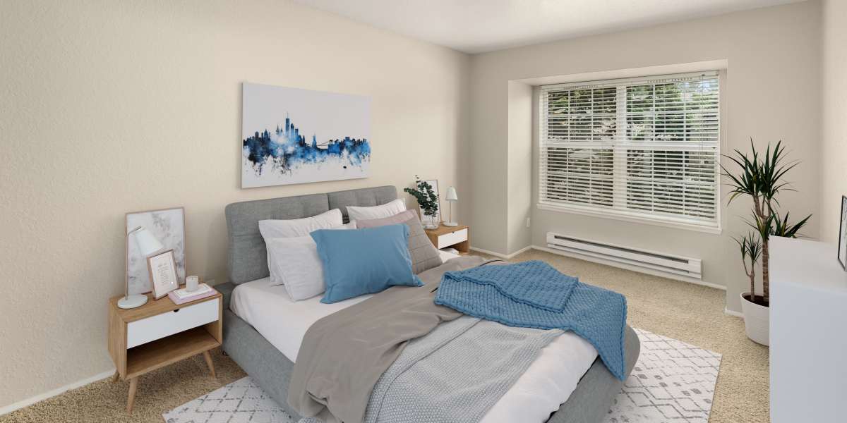 Spacious bedroom with natural light steaming in at Carriage Park Apartments in Vancouver, Washington