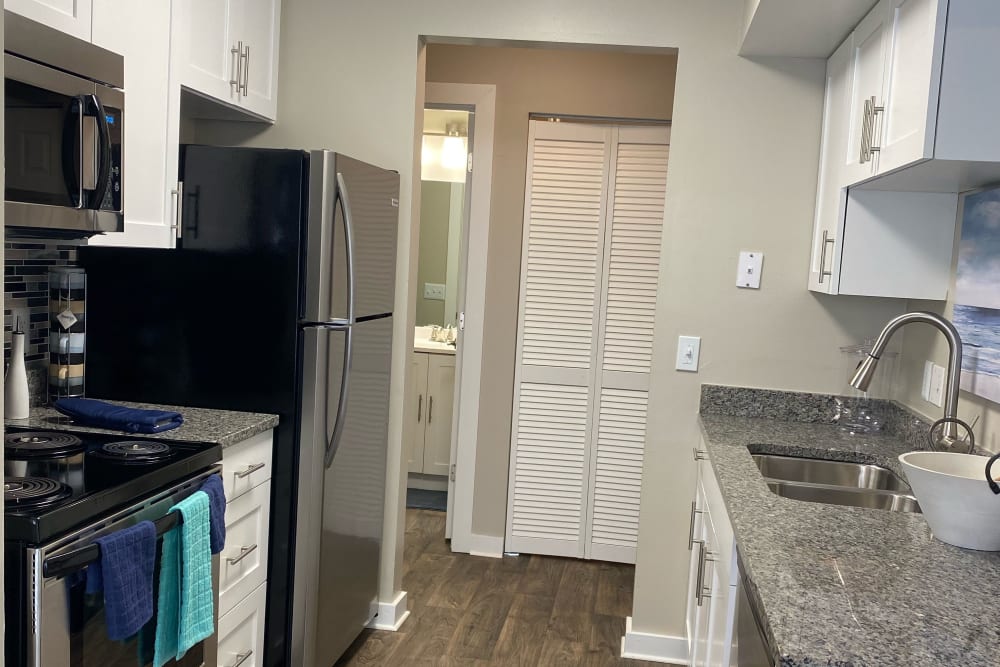 Kitchen with white cabinetry and stainless-steel appliances at Lakeshore Reserve Off 86th in Indianapolis, Indiana