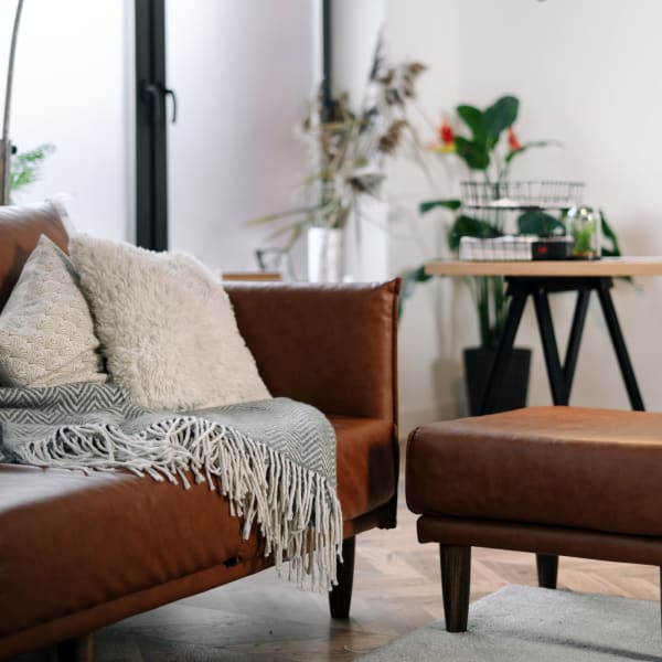 Stylish living room with leather sofa and love seat at The Mallory in Raleigh, North Carolina