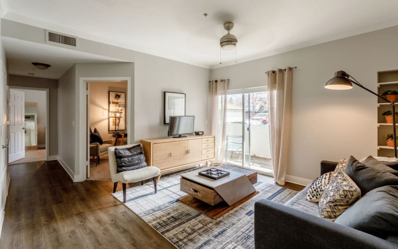 A decorated living room with hardwood style flooring at Altitude Westminster in Westminster, Colorado