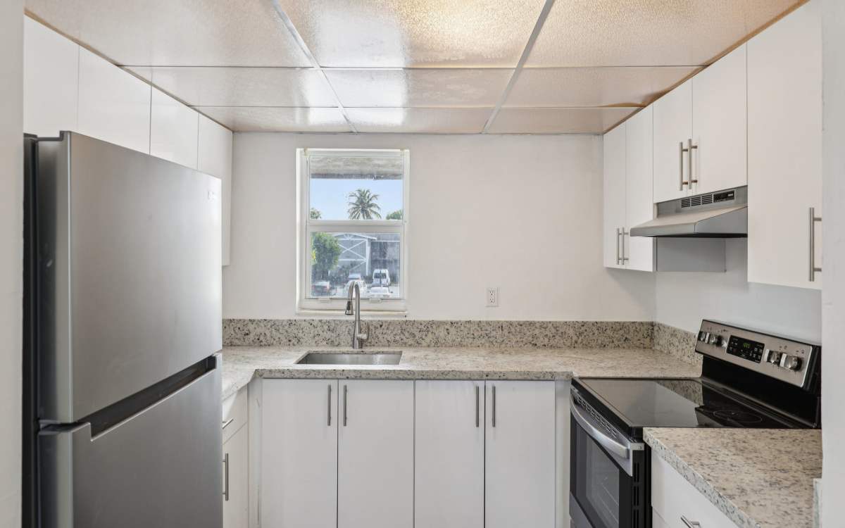 Kitchen room with modern and energy-efficient appliances at El Jardin Apartments in Hollywood, Florida