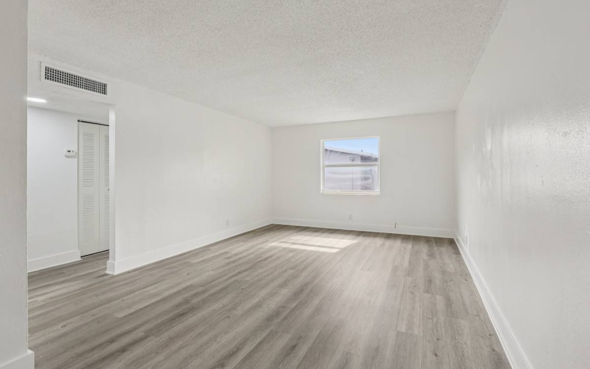 Spacious living room at El Jardin Apartments in Hollywood, Florida