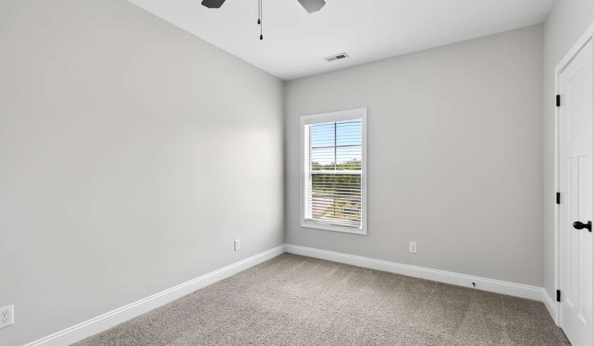 Unfurnished bedroom with carpt flooring and ceiling fan at Palomar Woods in Lexington, Kentucky