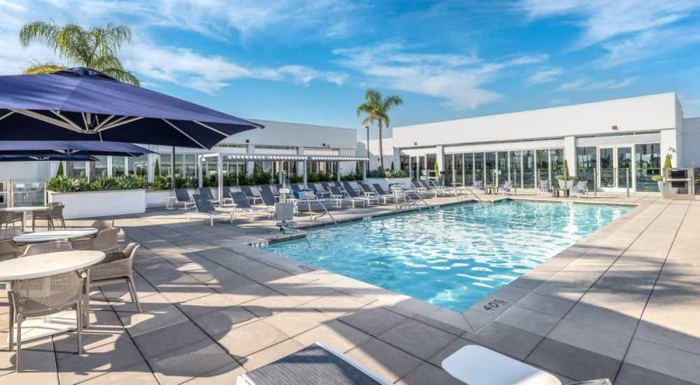 Swimming pool with pool loungers and cabana at The Beacon in Fremont, California