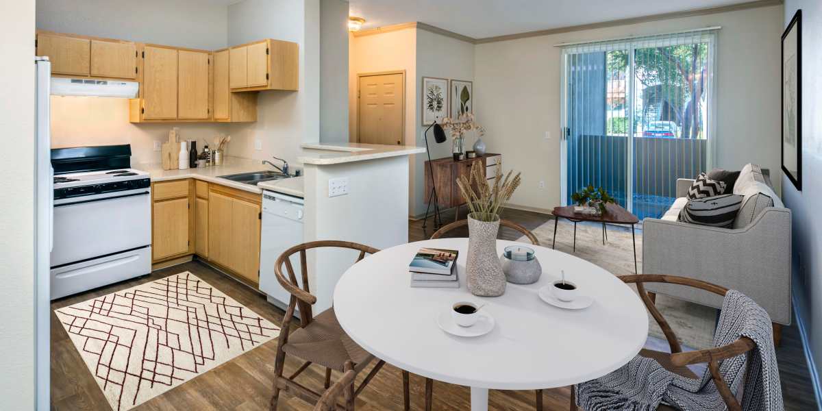 A dining room and kitchen at Natomas Park Apartments in Sacramento, California