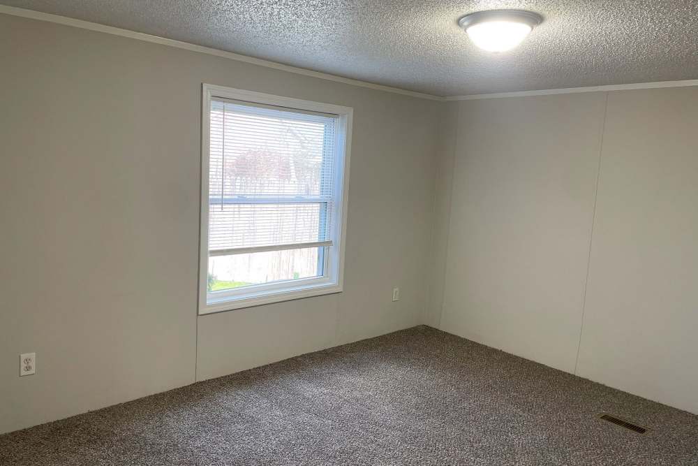 Apartment bedroom with plush carpeting at Fairview Crossing in Scottsburg, Indiana