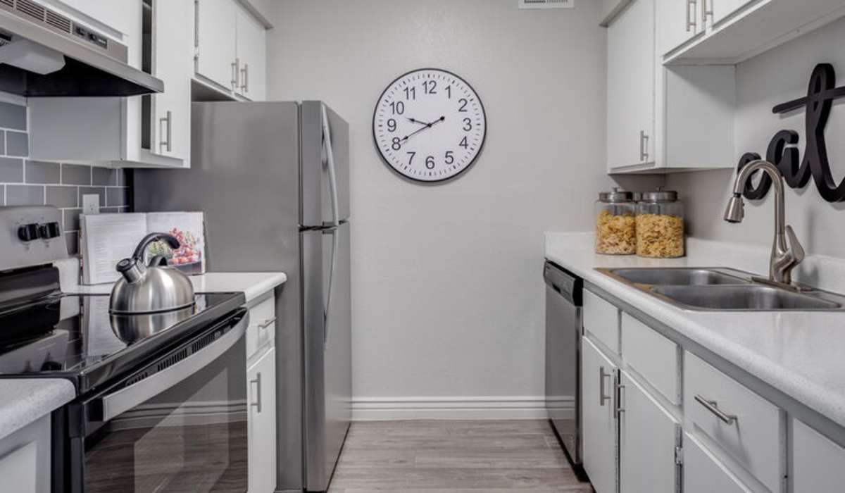 Stylish apartment kitchen with quartz-style countertops and wood-style flooring at 544 Southern Apartments in Mesa, Arizona