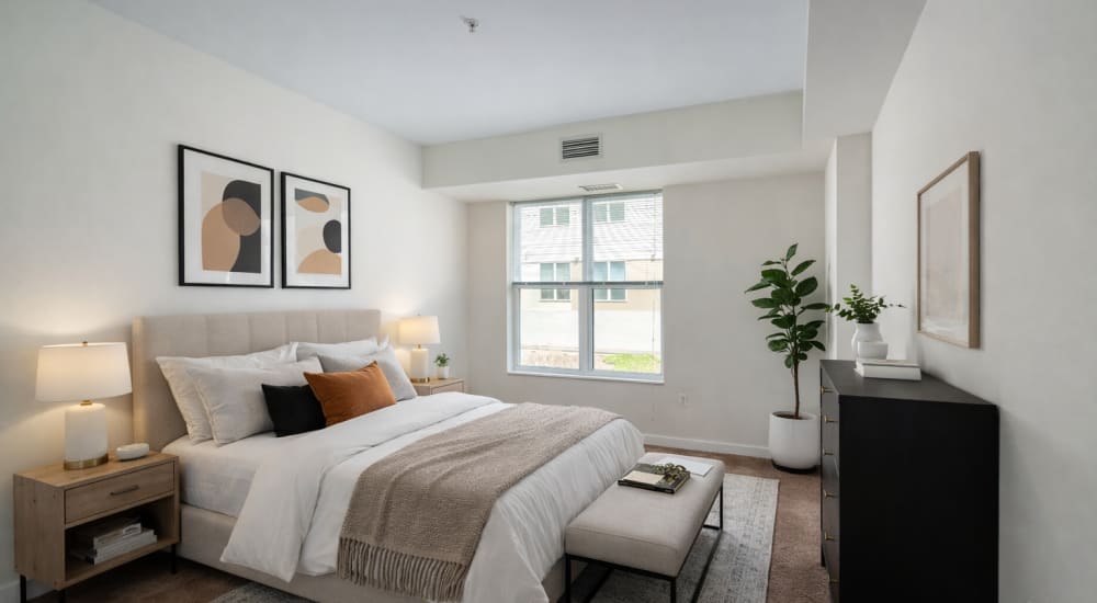 Bedroom staged featuring a large window at Paseo Verde in Philadelphia, Pennsylvania