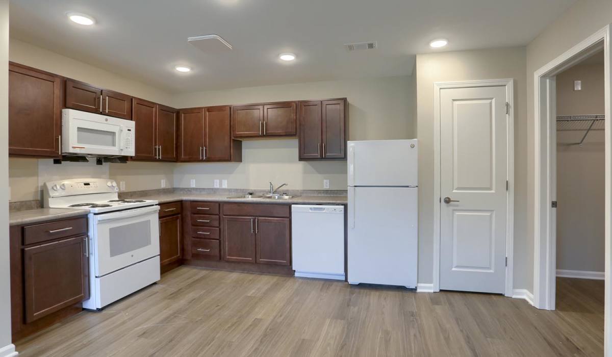 Kitchen includes wood cabinetry and stainless appliances at Normandy Lofts in Shippensburg, Pennsylvania