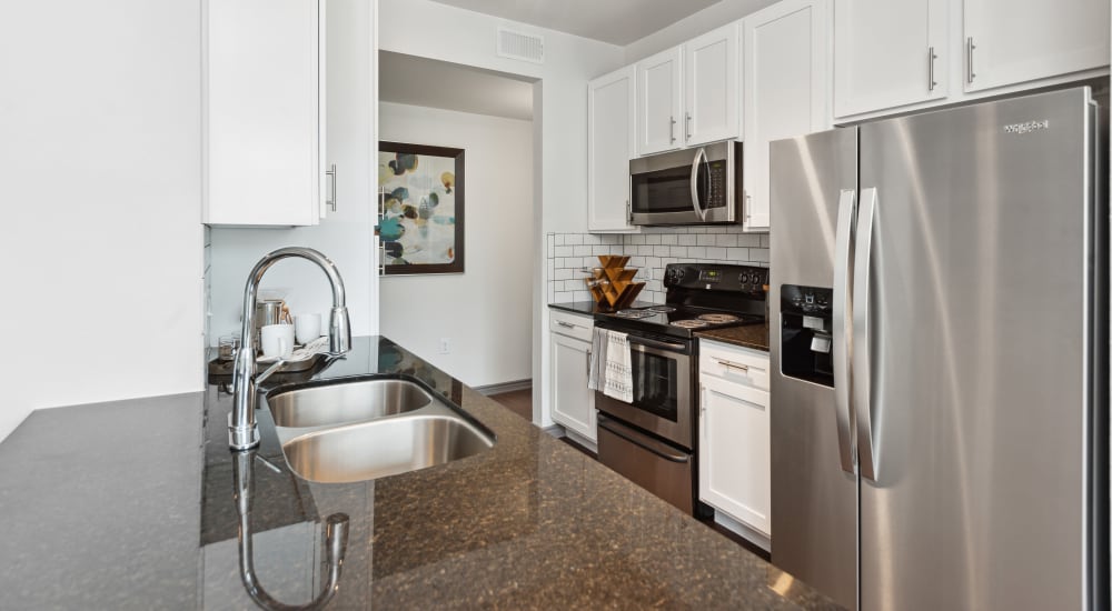 Kitchen with granite countertops and stainless-steel appliances at Haven at Eldridge in Houston, Texas