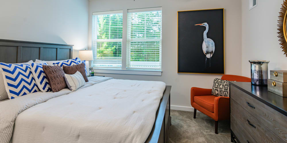 An apartment bedroom with the door open to the living room at Glenmoor Oaks in Moseley, Virginia