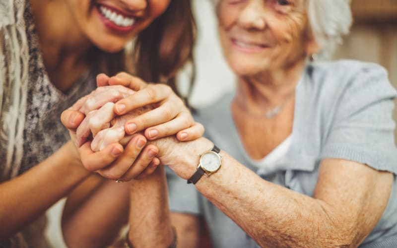 Resident and staff member posing for a photo together at Grand Villa of Palm Coast in Palm Coast, Florida