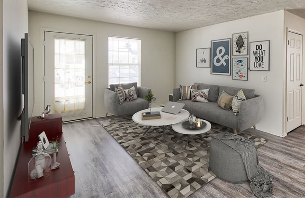 Living room with plank flooring in a model home at Westview Commons Apartments in Rochester, New York