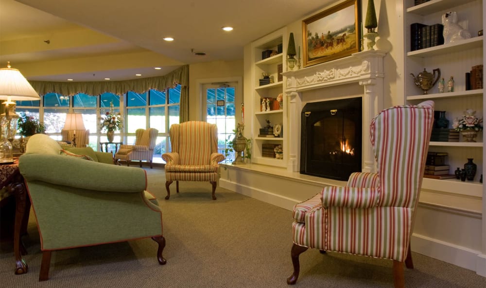 Sit by the fireplace in the community area at Equinox Terrace in Manchester Center, Vermont