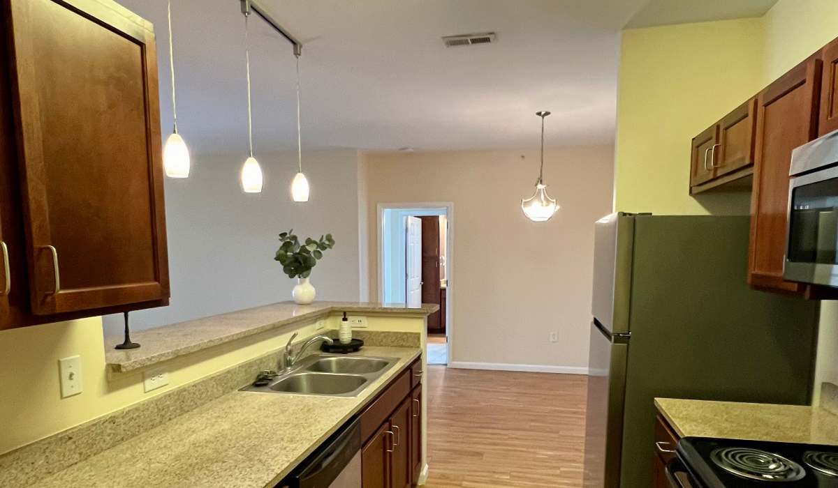 Kitchen with refrigerator at The Enclave Apartments in Columbus. IN