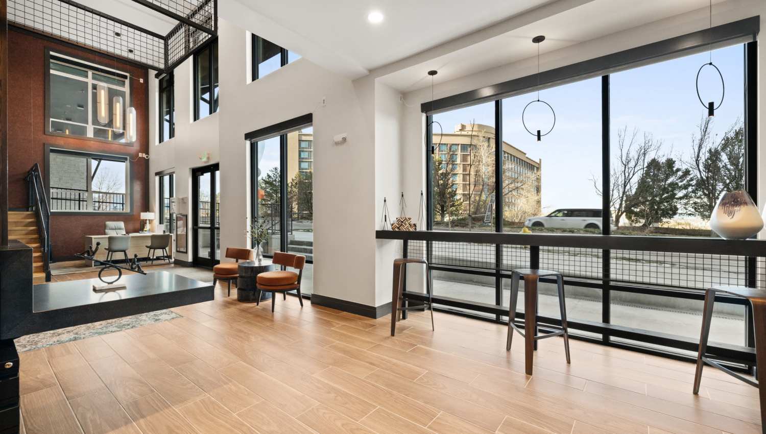 Clubhose with full height window and wood-style flooring at The Lock at Flatirons in Broomfield, Colorado