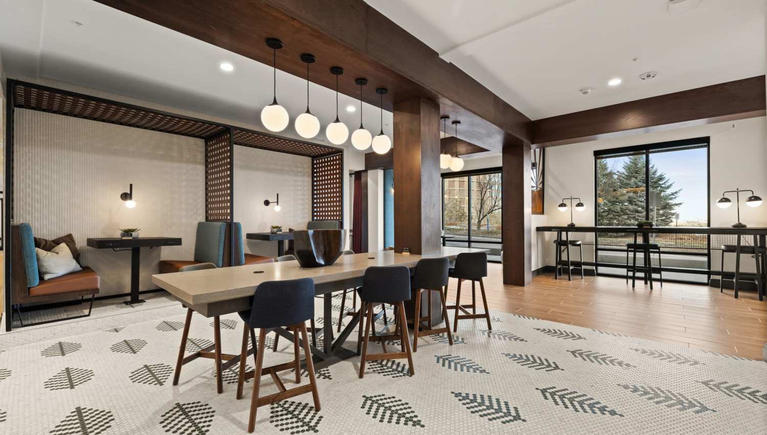 Interior view of a community clubhouse dining area with tables and chairs at The Lock at Flatirons in Broomfield, Colorado