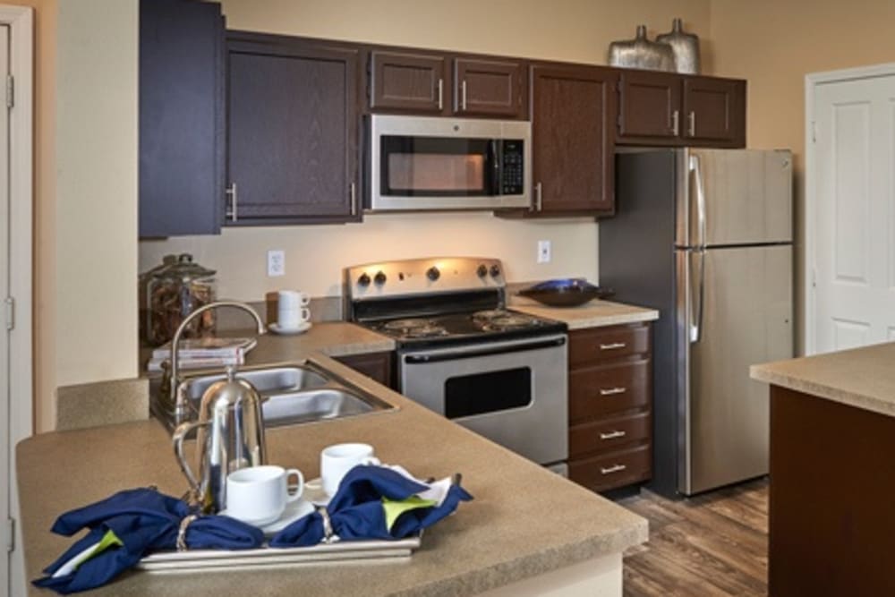 Kitchen with plenty of cabinet space at Legend Oaks Apartments in Aurora, Colorado