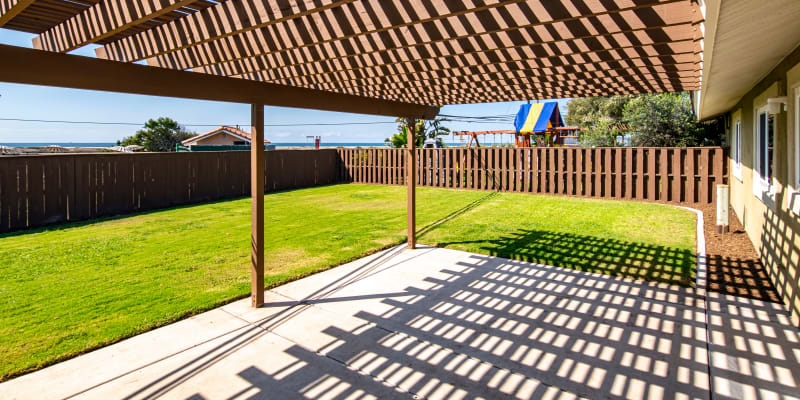 A covered patio and backyard at a home at Silver Strand I in Coronado, California