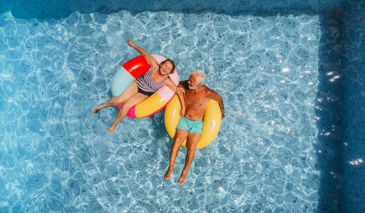Resident friends enjoying in swimming pool at Heirloom at Torrey Pines in Las Vegas, Nevada