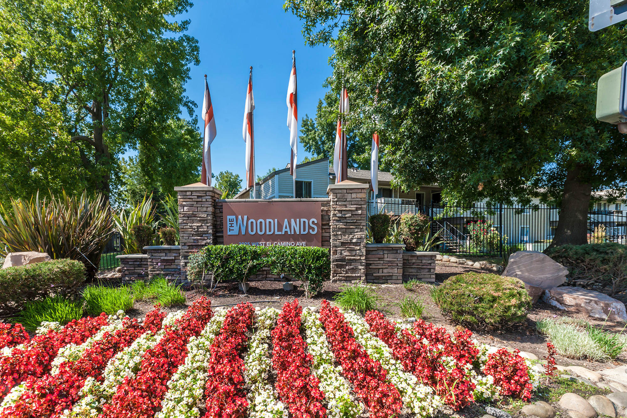 Monument sign at The Woodlands Apartments in Sacramento, California