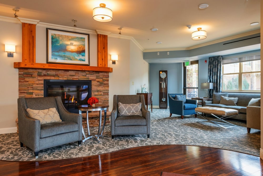 Well lit lounge seating area with hardwood floors at The Palisades at Broadmoor Park in Colorado Springs, Colorado