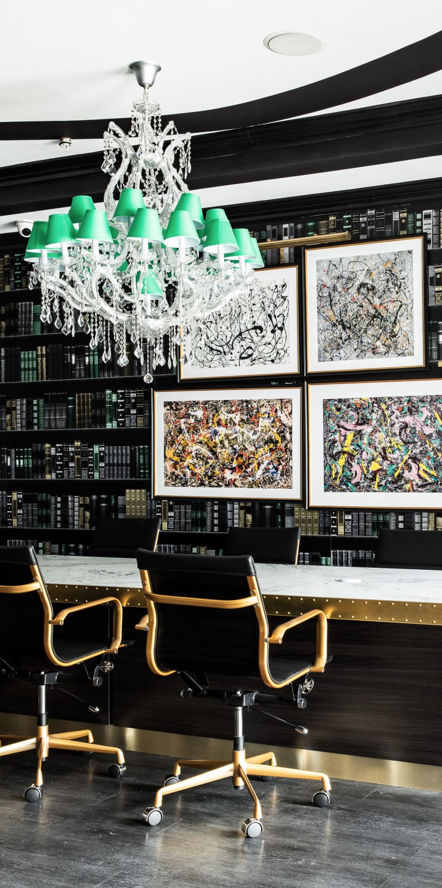 Resident clubhouse with a green chandelier and long conference table at University Village in Greensboro, North Carolina