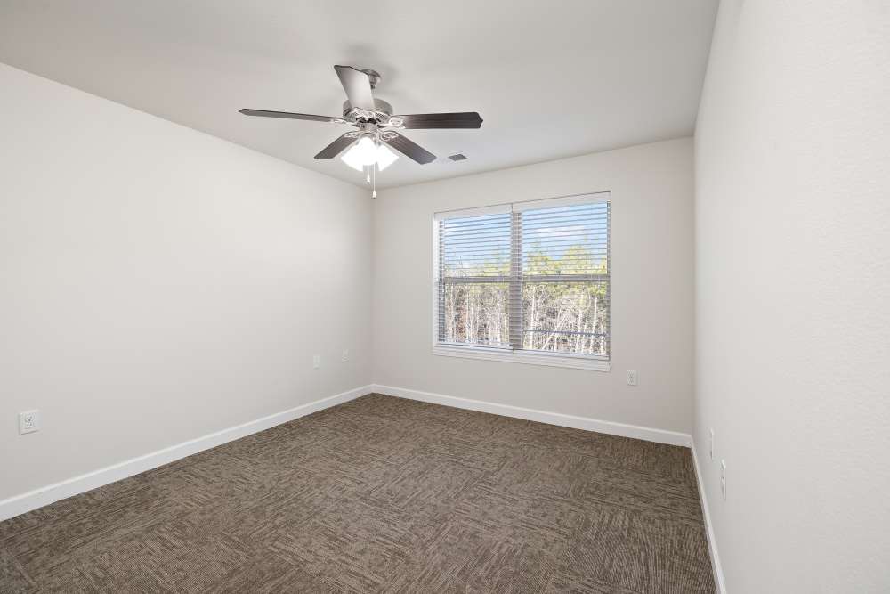 Unfurnished bedroom with ceiling fan at Harbor West Villas in Warsaw, Missouri