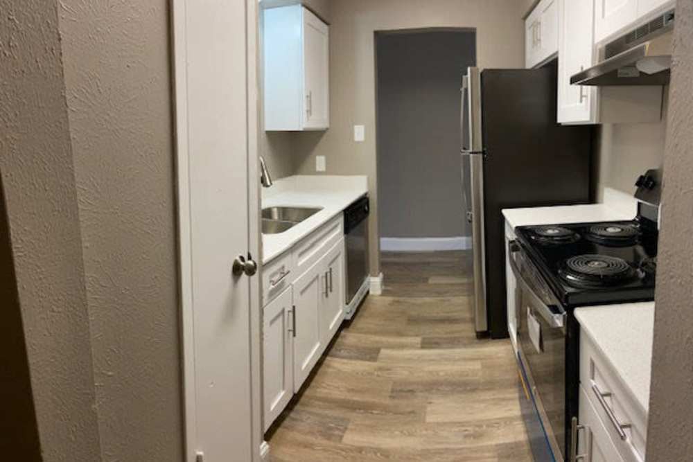 Modern kitchen with stainless-steel appliances at Mission Pointe Club Apartments in Euless, Texas